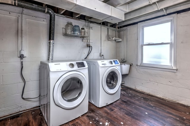 laundry area with washing machine and dryer and dark hardwood / wood-style floors