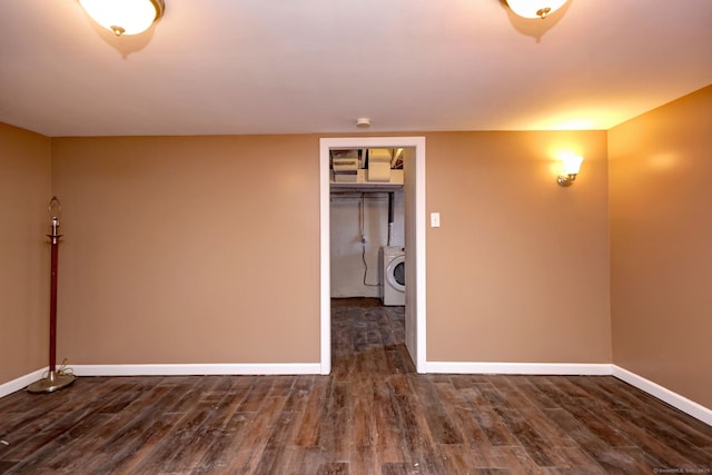 unfurnished room with dark hardwood / wood-style floors and washer / dryer