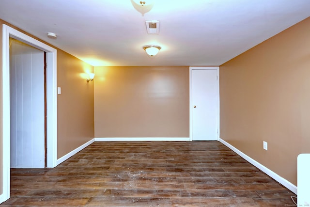 unfurnished room with dark hardwood / wood-style floors