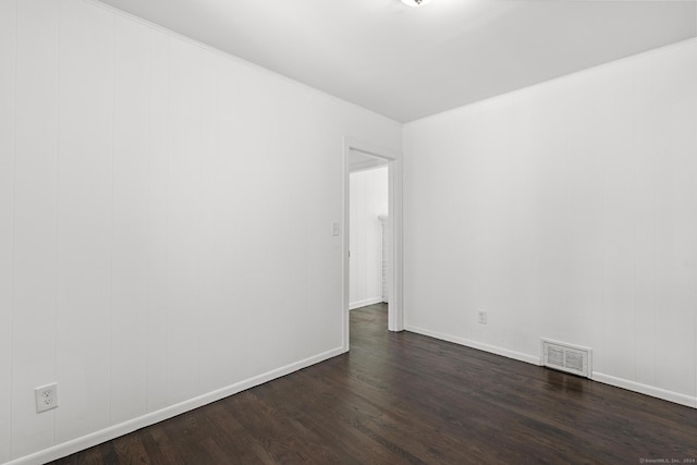 empty room with dark hardwood / wood-style flooring