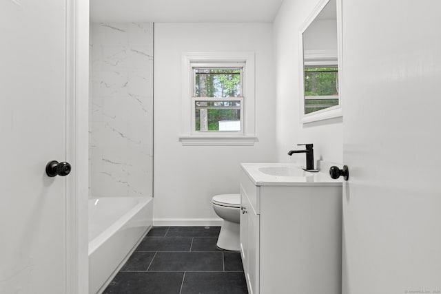 full bathroom featuring tile patterned flooring, vanity, toilet, and tiled shower / bath combo