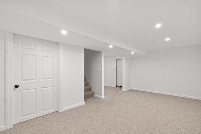 basement featuring light carpet