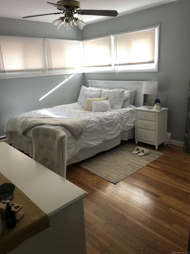 bedroom with ceiling fan and dark hardwood / wood-style floors