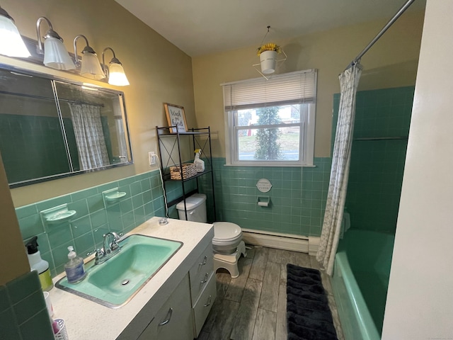 full bathroom featuring hardwood / wood-style floors, baseboard heating, shower / bath combo, and tile walls