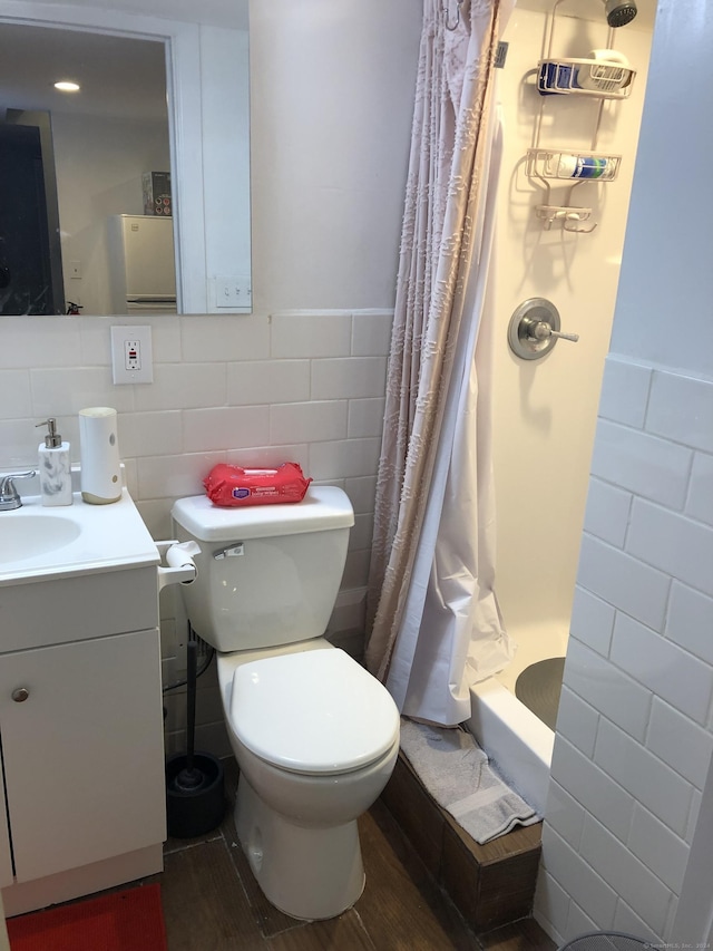 bathroom with toilet, vanity, tile walls, and hardwood / wood-style flooring