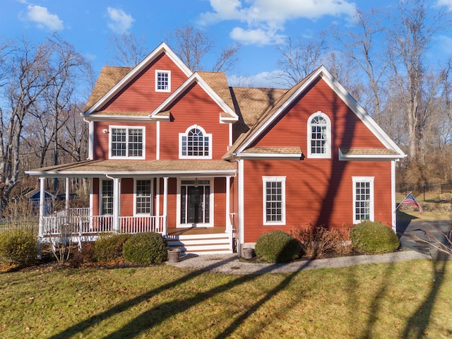 view of front of home with covered porch and a front yard