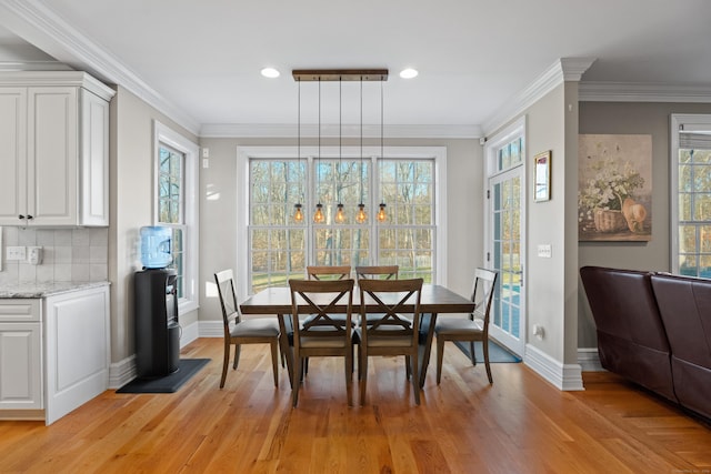 dining room featuring crown molding and light wood-type flooring