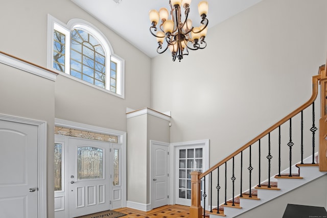 foyer entrance with a high ceiling and an inviting chandelier