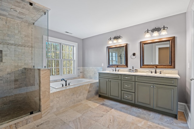 bathroom with shower with separate bathtub and vanity