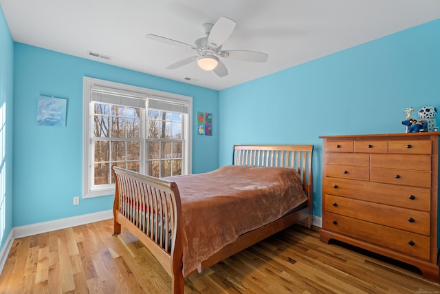 bedroom with ceiling fan and light hardwood / wood-style floors