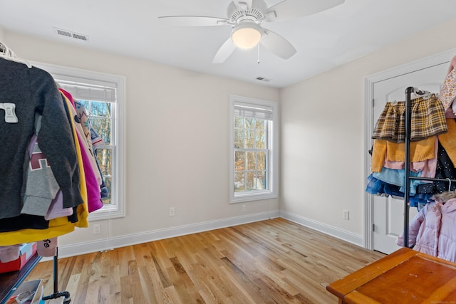 misc room featuring light wood-type flooring, a wealth of natural light, and ceiling fan