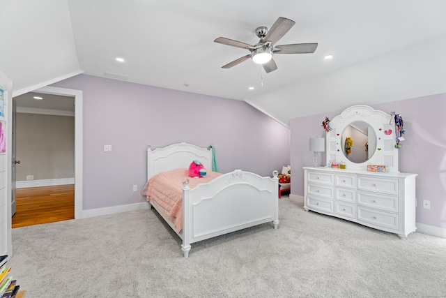 bedroom with light colored carpet, vaulted ceiling, and ceiling fan