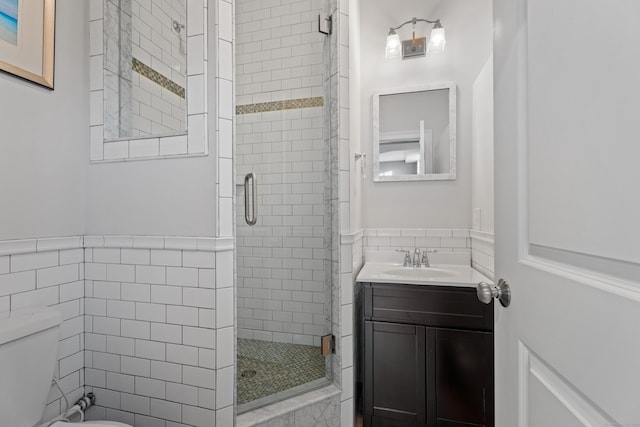 bathroom with vanity, an enclosed shower, and toilet