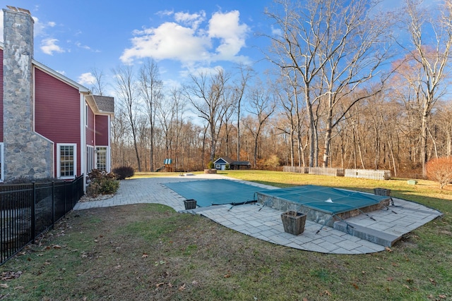 view of pool with a yard and a patio area