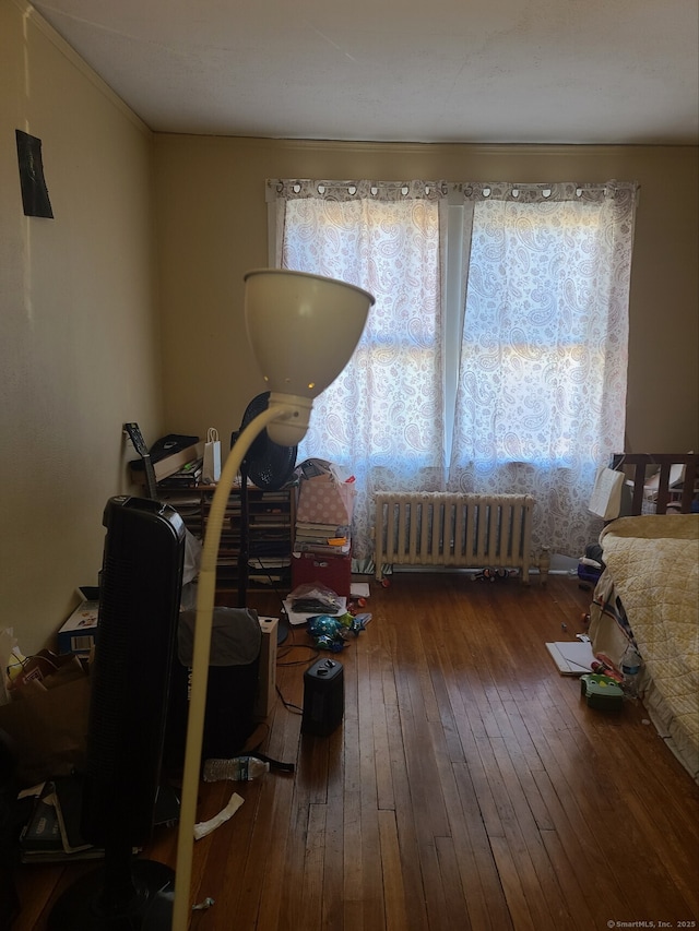 miscellaneous room featuring radiator heating unit and dark wood-type flooring