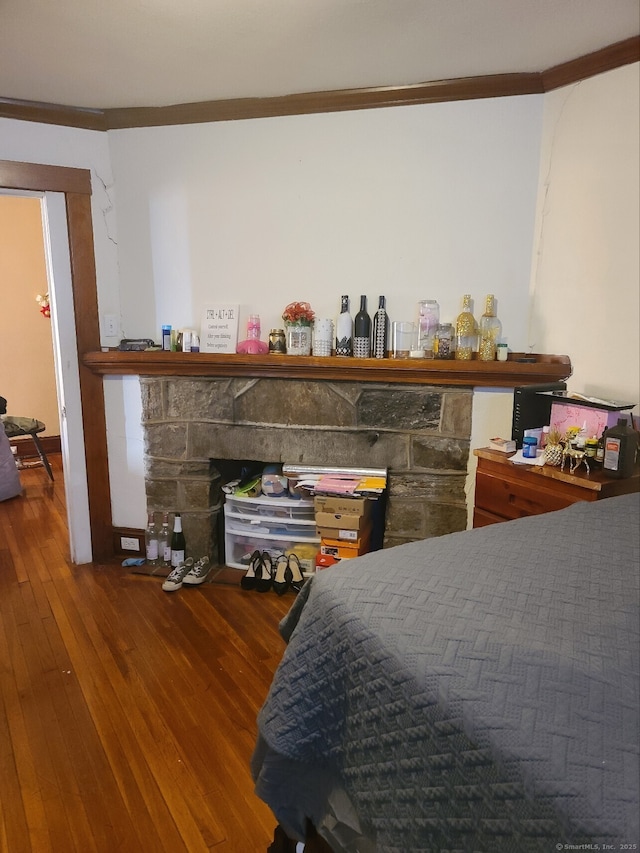 bedroom with hardwood / wood-style flooring and crown molding