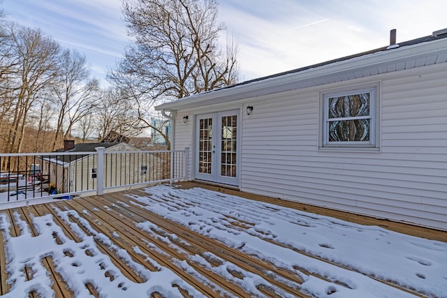 snow covered deck featuring french doors