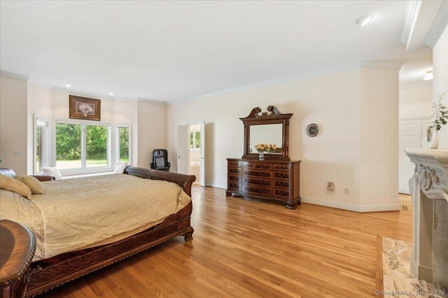 bedroom featuring ornamental molding and light wood-type flooring