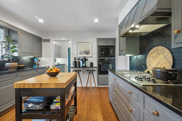 kitchen with dark countertops, gray cabinets, and black appliances