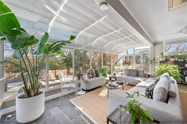 sunroom / solarium with a ceiling fan