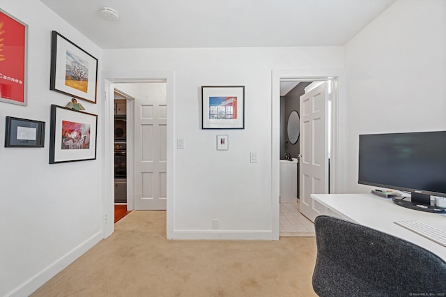 office area with light carpet and baseboards