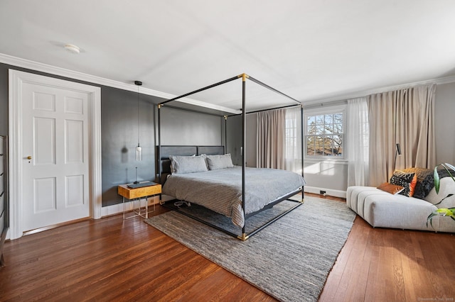 bedroom featuring crown molding, baseboards, and hardwood / wood-style floors