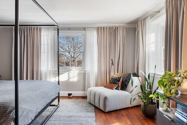 bedroom with dark wood-type flooring and baseboards