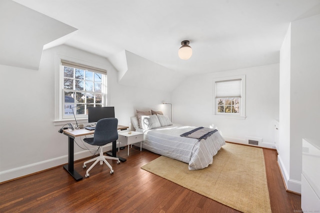 bedroom featuring baseboards, visible vents, vaulted ceiling, and dark wood-style flooring