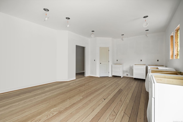 interior space with washer / dryer and light hardwood / wood-style flooring