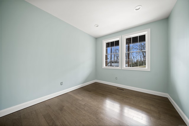 spare room with hardwood / wood-style floors