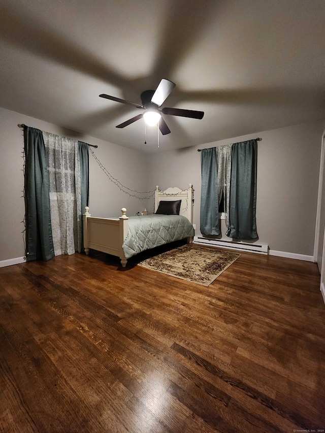 unfurnished bedroom featuring hardwood / wood-style floors, ceiling fan, and a baseboard heating unit