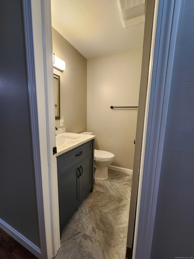 bathroom with vanity and toilet