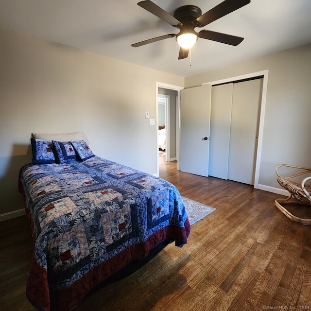 bedroom with hardwood / wood-style floors, a closet, and ceiling fan