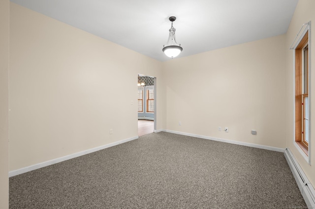 spare room with carpet floors and baseboard heating