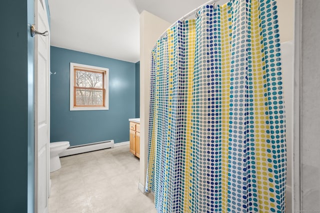 bathroom with vanity, toilet, walk in shower, and a baseboard heating unit