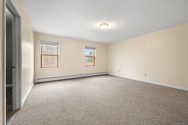 empty room with carpet flooring and a baseboard heating unit