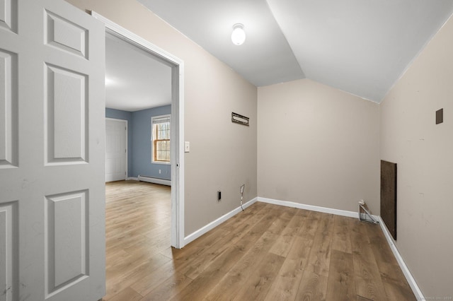 laundry area featuring light hardwood / wood-style floors and a baseboard heating unit