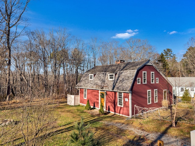 rear view of house with a yard