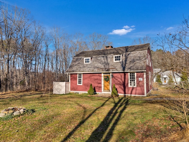 back of house with a lawn