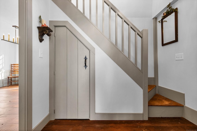 stairs featuring wood-type flooring