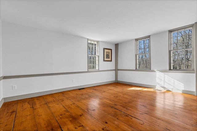 unfurnished room with hardwood / wood-style floors