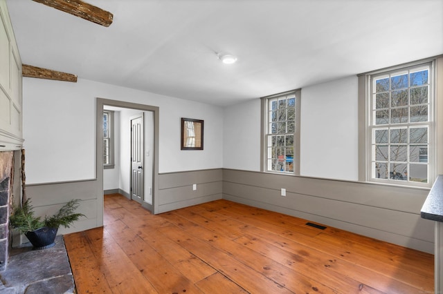 spare room with a healthy amount of sunlight and light hardwood / wood-style floors