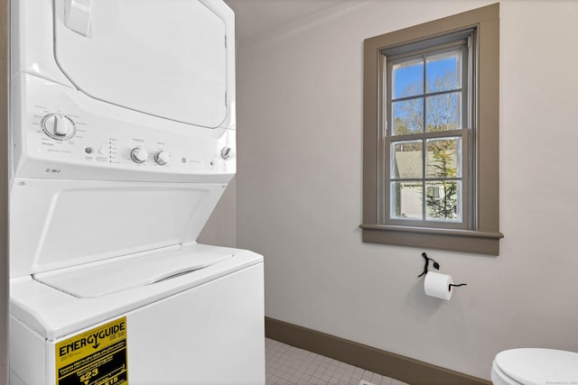 laundry room with stacked washing maching and dryer