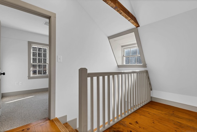 hallway with vaulted ceiling with beams and wood-type flooring