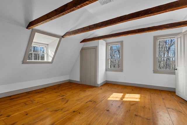 bonus room with vaulted ceiling with beams, light hardwood / wood-style floors, and a wealth of natural light