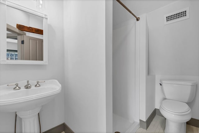 bathroom with a shower and toilet