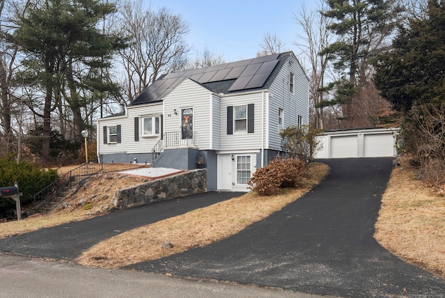 view of front of property featuring an outdoor structure and a garage