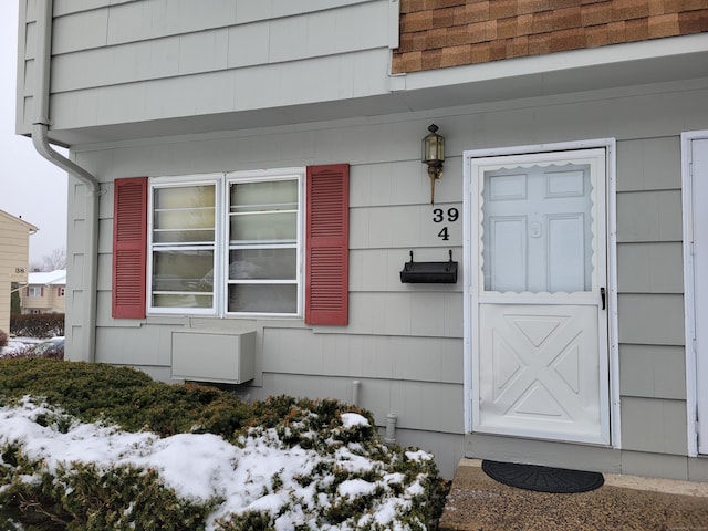 view of snow covered property entrance