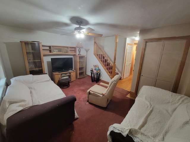 living room with ceiling fan and dark colored carpet