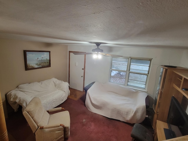 carpeted bedroom with a textured ceiling and ceiling fan